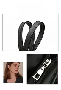 Detail of reinforced black Oxford tote handle with silver metal hardware and fine stitching