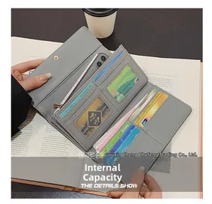 Detailed interior view of a gray long wallet showing multiple card slots and phone pocket