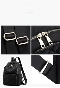Detail shot of black quilted nylon backpack featuring metallic zippers and adjustable straps