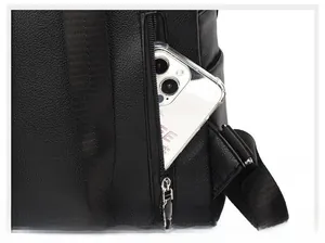 Detail of the hidden rear security zipper pocket on a black pebble grain leather backpack