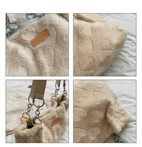 Detail shot of beige plush tote bag featuring 3D heart textures and metal chain strap