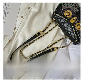 Detail of colorful beads, sequins and rivets on a quilted black leather crossbody bag