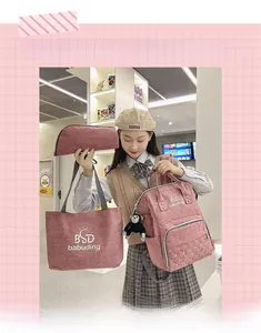 Three-piece pink quilted mummy bag set featuring backpack, tote and small pouch