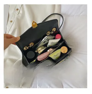 Internal view of black quilted bag showing multi-layer compartments and storage capacity