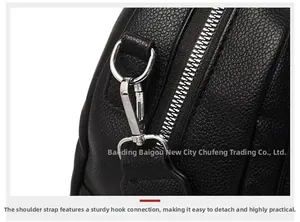 Close-up of litchi pattern leather bag with premium silver metal zipper and hardware hooks
