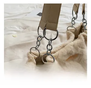 Detail of plush tote bag showing diamond texture, gold metal rings and PU leather strap
