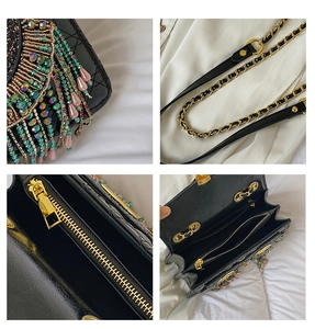 Close-up of colorful beadwork and golden chain details on a black diamond quilted bag