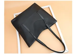 Macro detail of black Oxford cloth tote bag showing dual vertical stitching and texture