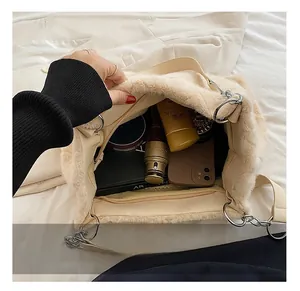 Spacious interior of fluffy cream tote bag showing lining and zipper pocket detail
