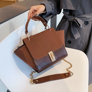 Brown wing-shaped shoulder bag with crocodile texture and matte finish stitching