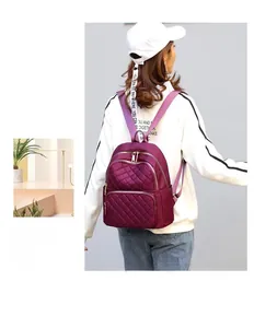 Asian model wearing a burgundy quilted nylon backpack with chic diamond lattice pattern