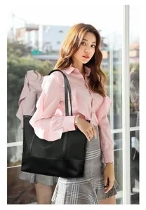 Detail of a large black Oxford cloth tote bag with shoulder straps for urban leisure use