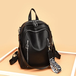 Fashionable black pebbled leather backpack with multi-zipper design and geometric strap