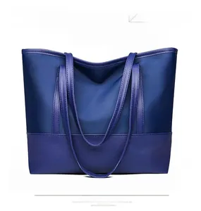 Close-up of dual-tone blue Oxford tote bag showing durable fabric and spacious design
