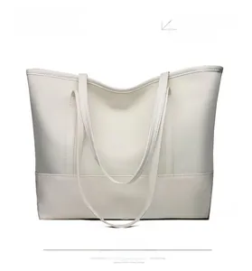 Detailed front view of the minimalist white Oxford cloth tote bag with long handles