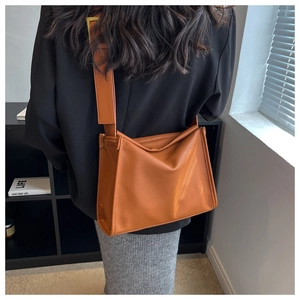 Detailed view of caramel large tote bag with litchi texture and wide shoulder strap