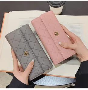 Detail of pink and grey quilted faux leather wallets with elegant golden flower clasps