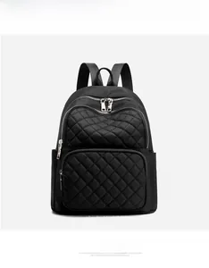 Front view of black quilted nylon backpack featuring dual front zipper pockets and side pockets