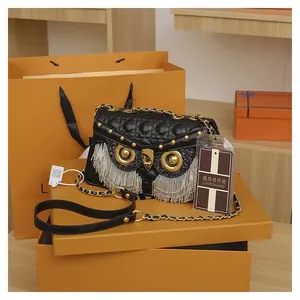 Detail of owl-shaped quilted crossbody bag with silver fringe and gold chain strap