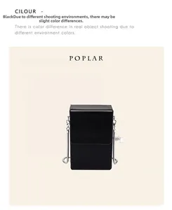Detailed close-up of the black leather textured mini phone bag with silver chain strap