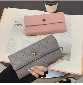 Detail view of quilted long wallets with camellia metal buckles in pink and grey