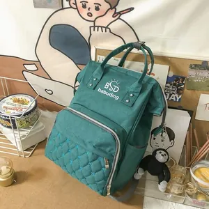 Close-up of waterproof nylon mummy bag with diamond stitching and iconic ape keychain