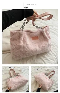 Detail of pink faux fur tote bag showing plush heart pattern and metal chain strap