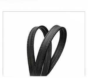 Close-up of durable double-stitched leather handles on a black Oxford tote bag