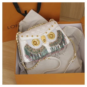 Detail of owl crossbody bag with white quilted leather, colorful beads, and gold chain strap