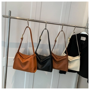 Detail of minimalist leather shoulder bags in four colors with adjustable metal buckles