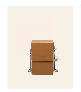 Close-up of brown textured leather crossbody mini bag with metal chain strap and logo