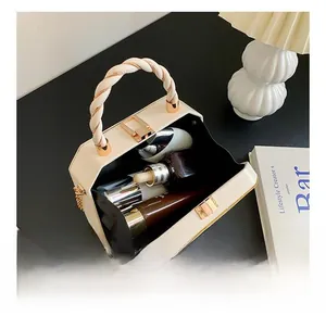 Interior view of cream hexagonal box bag showing storage for makeup and cosmetics