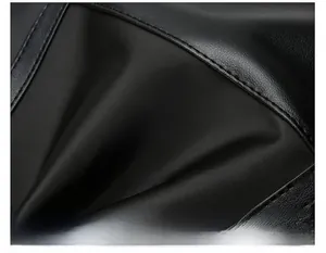 Detailed macro view of black faux leather texture with durable reinforced stitching