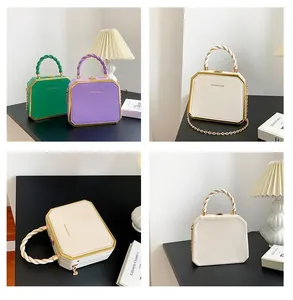 Detailed view of hexagonal hardshell bags in green, purple and white with chain strap