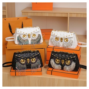 Detail of owl-shaped crossbody bags with diamond quilting, tassels and gold hardware