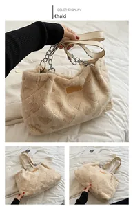 Detail of khaki faux fur tote bag with heart patterns and metallic chain handle