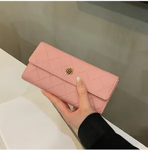 Pink quilted long wallet featuring a floral metal twist lock and elegant stitching detail
