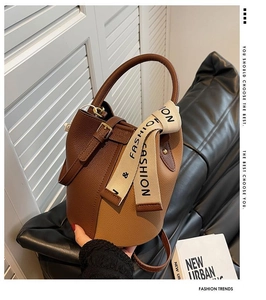 Close-up of color-block bucket bag showing lychee grain leather and fashion strap