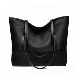 Large black Oxford fabric tote bag with leather bottom and reinforced handles on white background