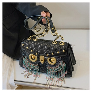 Detail of owl-shaped crossbody bag with colorful bead tassels and black quilted leather