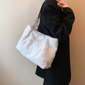 White faux fur heart embossed tote bag with chain strap and brand logo patch