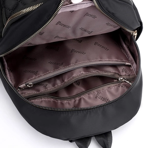 Black quilted nylon backpack with a spacious interior and gold-tone zippers