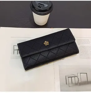 Detailed close-up of quilted pattern long wallet with elegant golden camellia logo