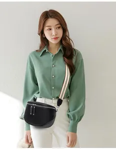 Détail d'un sac de poitrine en cuir noir avec bandoulière rayée sur mannequin