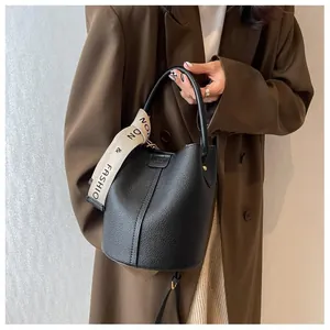 Close-up of litchi grain leather bucket bag with fashion letter shoulder strap