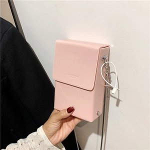 Pink mini crossbody phone bag with silver chain strap and brand logo engraving