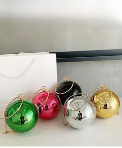 Group shot of colorful metallic spherical clutch bags with ring handles and chain straps