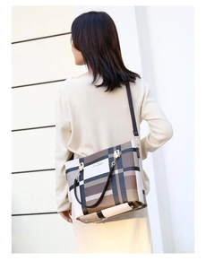 Detailed view of checkered large tote bag showing gold hardware and shoulder strap