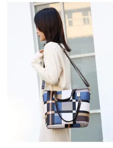 Close-up of a large capacity crossbody bag with a geometric color block pattern and strap