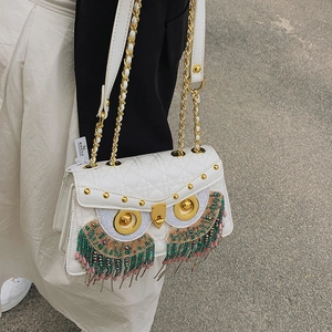 White quilted leather owl crossbody bag with fringe tassels and gold chain strap
